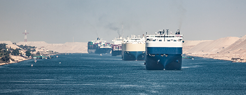 Cargo ships line up for passage through the Suez Canal in Egypt.