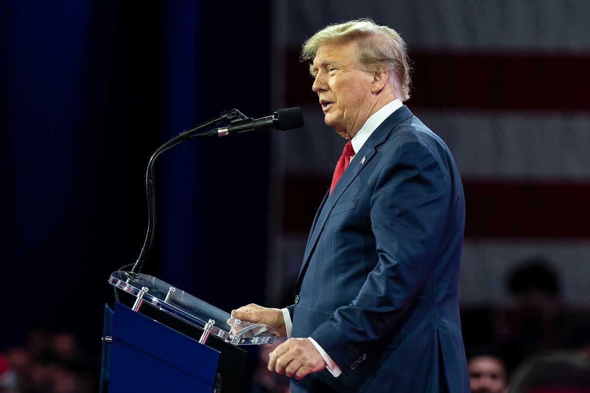 Former President Trump speaking at a podium 