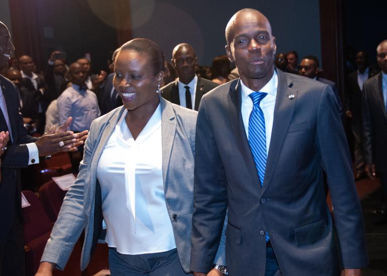 Recently assassinated Haitian President Moise and his wife walking into a room of people, giving them a standing ovation.