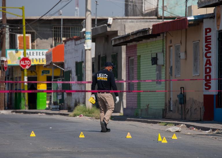 Experts work a targeted assassination crime scene in Mexico.