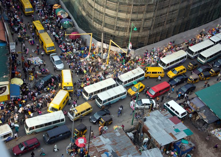 Top-down view of a chaotic 4-way street intersection in downtown Lagos, Nigeria to represent chaotic operational conditions.