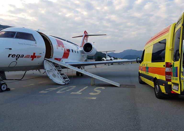 Ambulance van and airplane on a runway