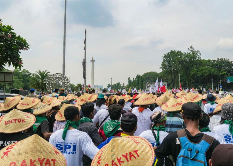 Indonesian farmers wearing hats, demonstrating in Jakarta.