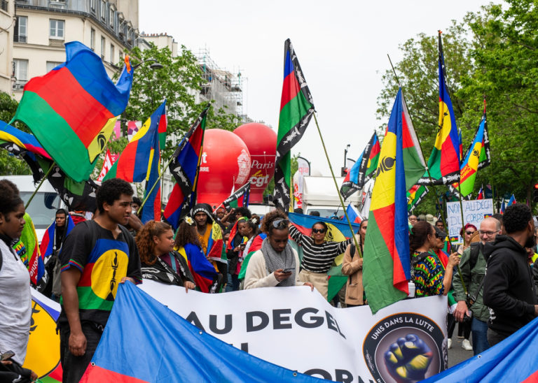 Indigenous Kanaks protesting in Paris against French lawmakers' proposal to allow long-term residents in the territory to vote in provincial elections