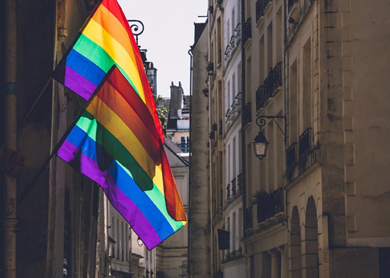 Two LGBTQ flags hanging in the streets of Paris