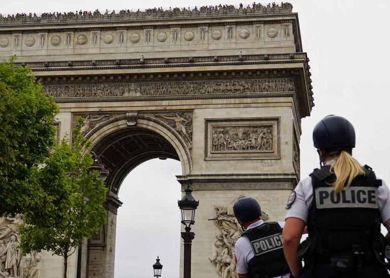 Arc de Triomphe and Police Officers on Horses in Paris City