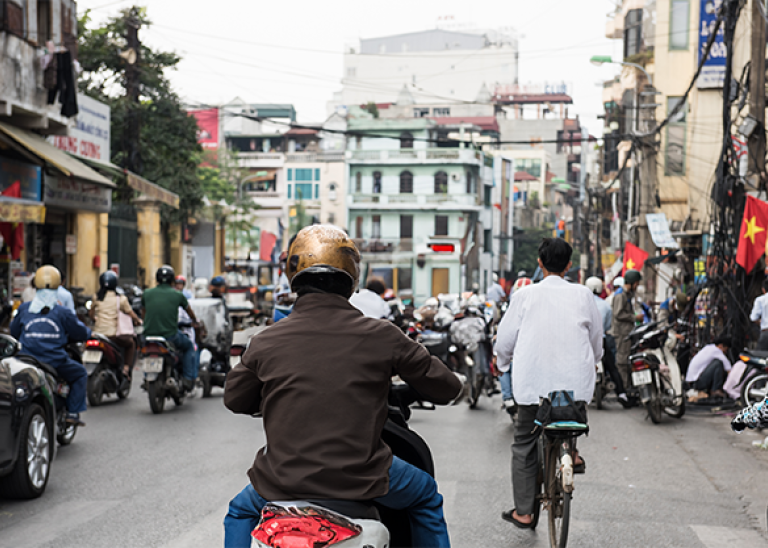 busy street of Bali with motorbikes and shops 