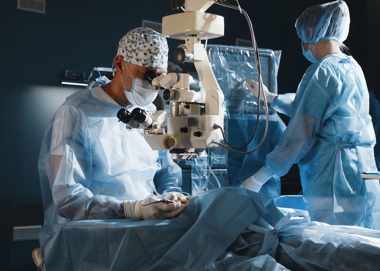 Doctor using a microscope during eye surgery