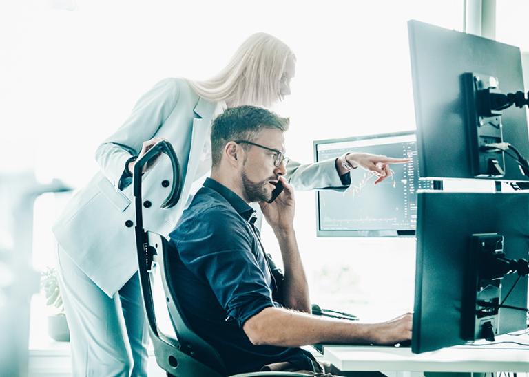 two analysts at a watch desk concept, monitoring, support and collaboration.