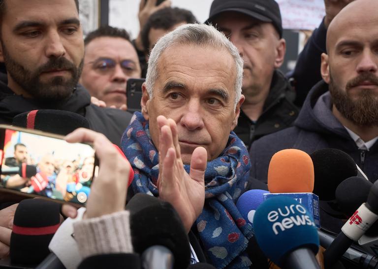 Far-right runoff candidate for the presidency of Romania, Calin Georgescu, speaks to the press at a closed polling station after the elections were legally annulled.