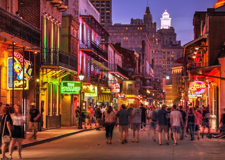 New Orleans, Louisiana, USA - Crowds of people walk along Bourbon Street