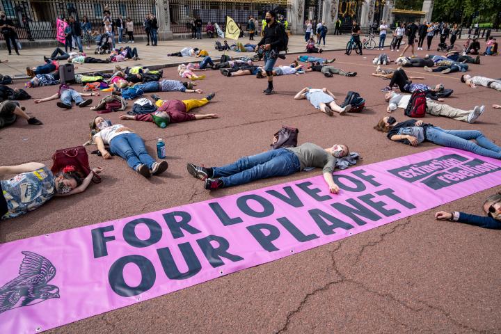 An example Extinction Rebellion protest event with climate activists laying down blocking a road in acts of civil disobedience. 