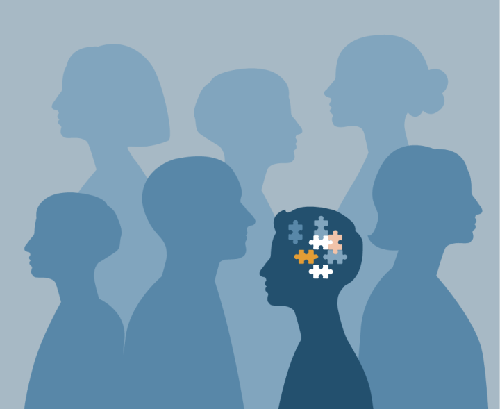 illustration of group of people in silhouette with one in dark blue and puzzle pieces in the head